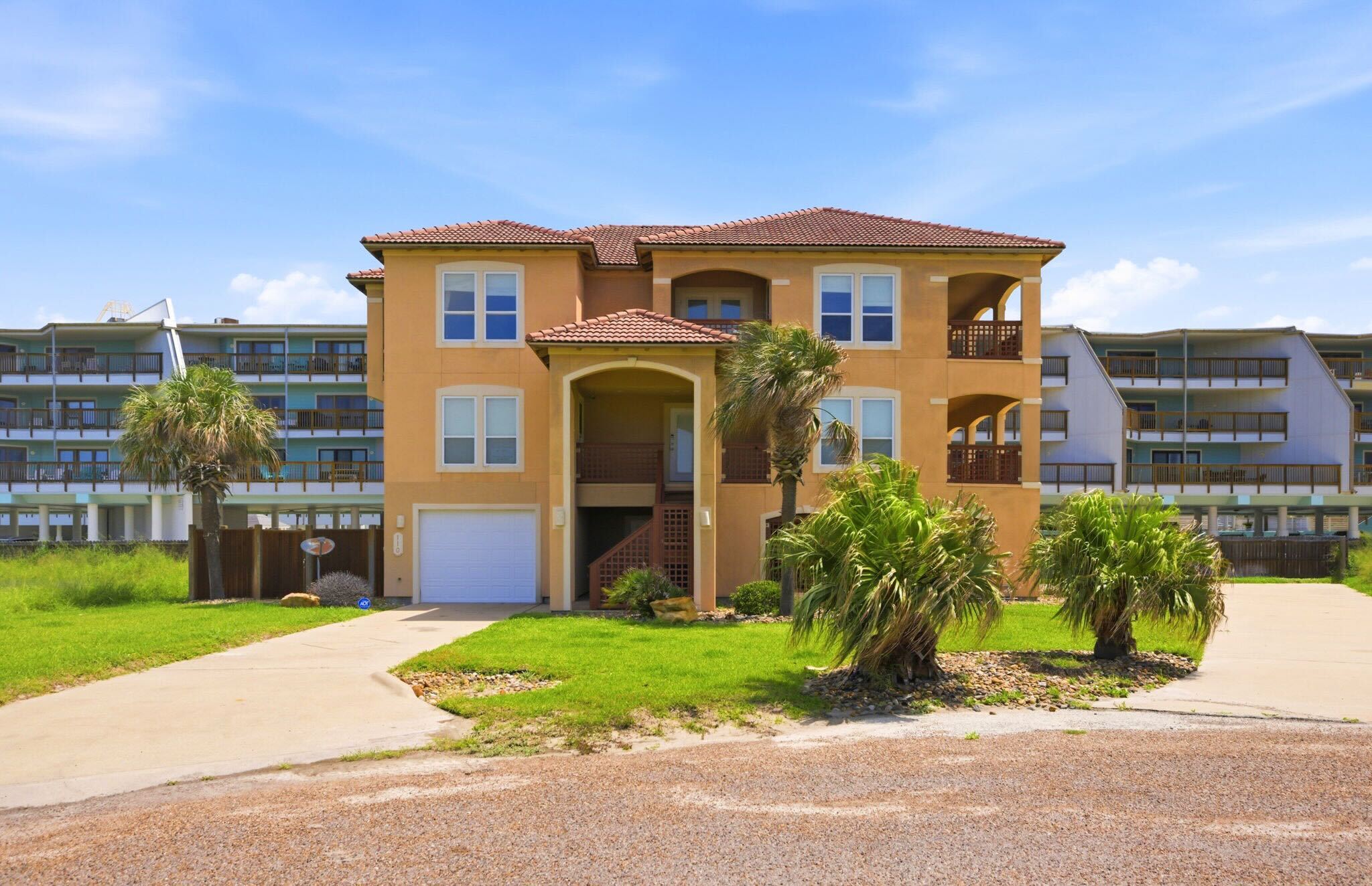 Front Exterior — Mediterranean-Style Home with Palm Trees
